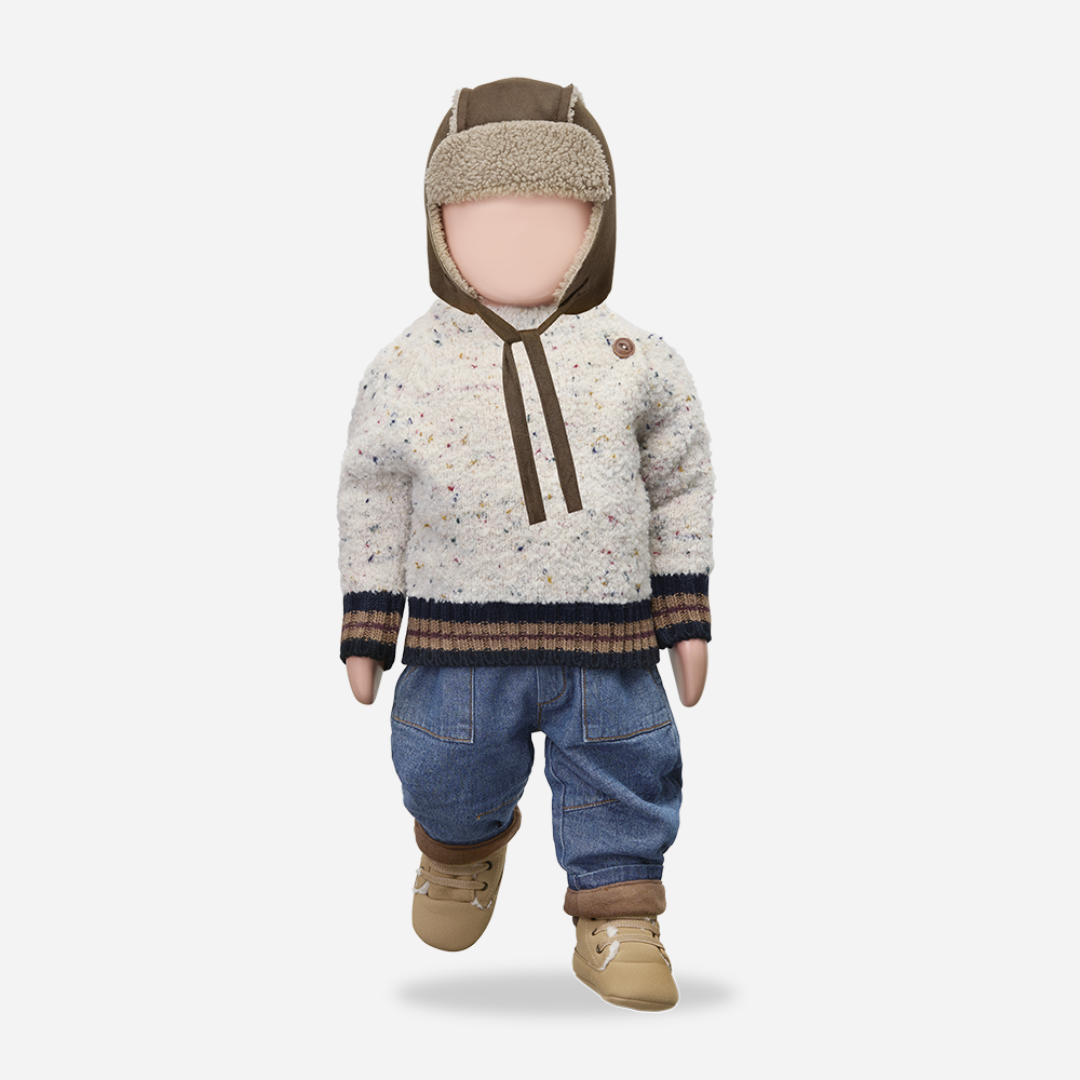 Sold at Bombon shop, designed by 1+ in the family — speckled knit baby sweater with contrast ribbed cuffs and buttoned shoulder, in cream with navy and brown accents. manequin