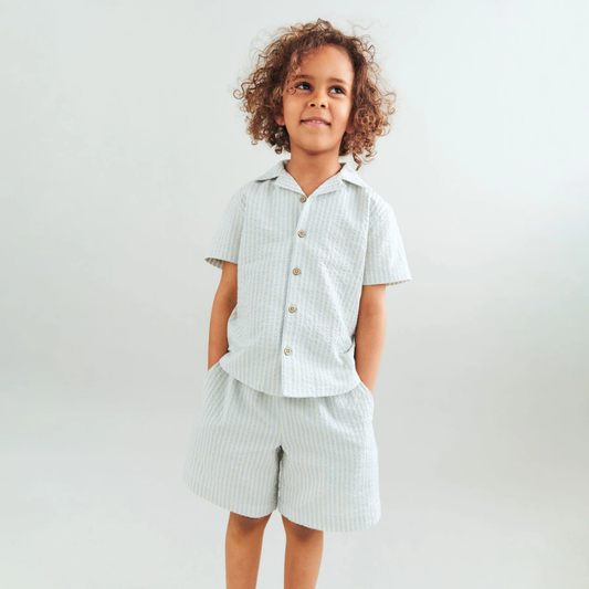 Sold at Bombon Shop, designed by Wheat, summer sky stripe organic cotton short sleeve button-down shirt with soft blue vertical stripes.