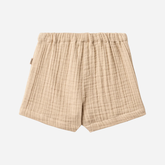 Sold at Bombon Shop, designed by Wheat, warm sand organic cotton kids shorts with subtle vertical stripes and elastic waistband.