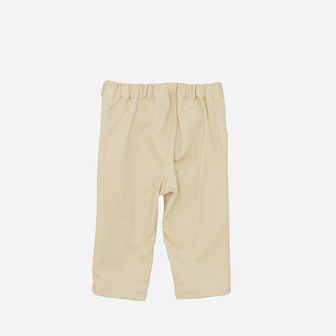Sold at Bombon shop, designed by Fina Ejerique, beige twill baby trousers with waistband button details and side pockets. back