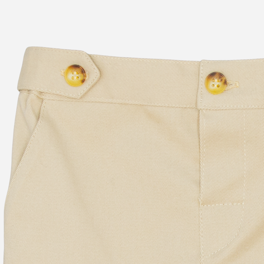 Sold at Bombon shop, designed by Fina Ejerique, beige twill baby trousers with waistband button details and side pockets. zoom