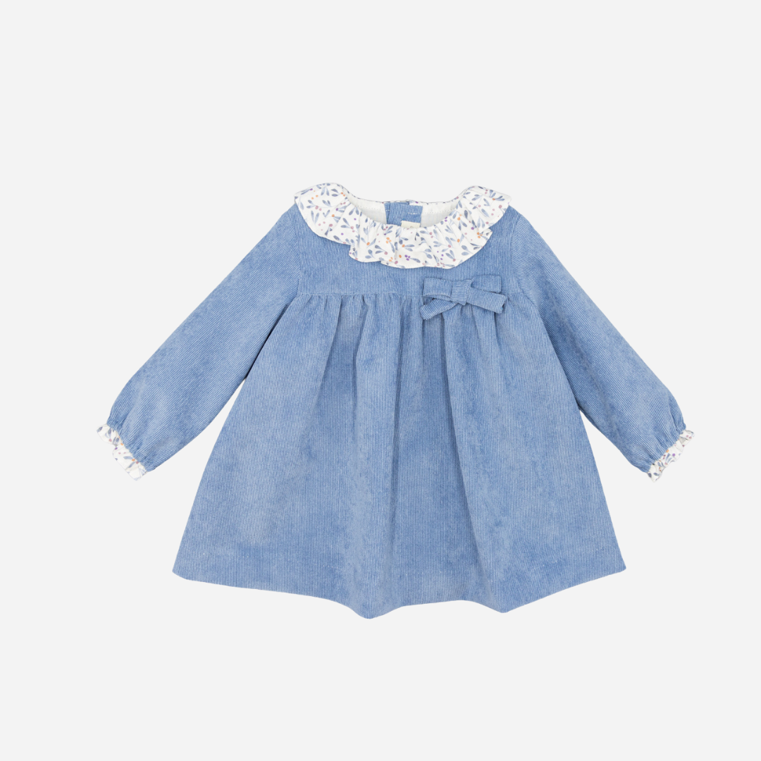 Sold at Bombon shop, designed by Fina Ejerique, a sky-blue corduroy baby dress with floral ruffle collar, bow detail, and long sleeves. front
