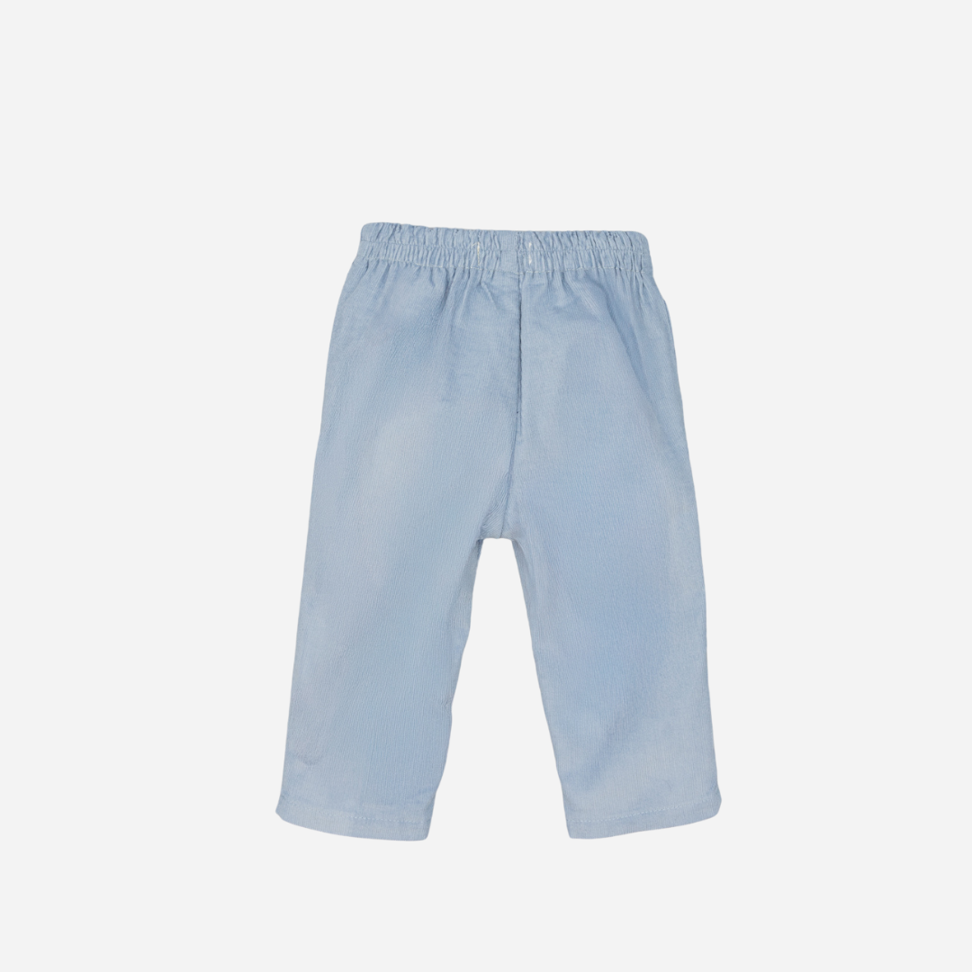 Sold at Bombon shop, designed by Fina Ejerique, a pair of sky-blue corduroy baby pants with scallop-trimmed back pockets and elastic waistband. back