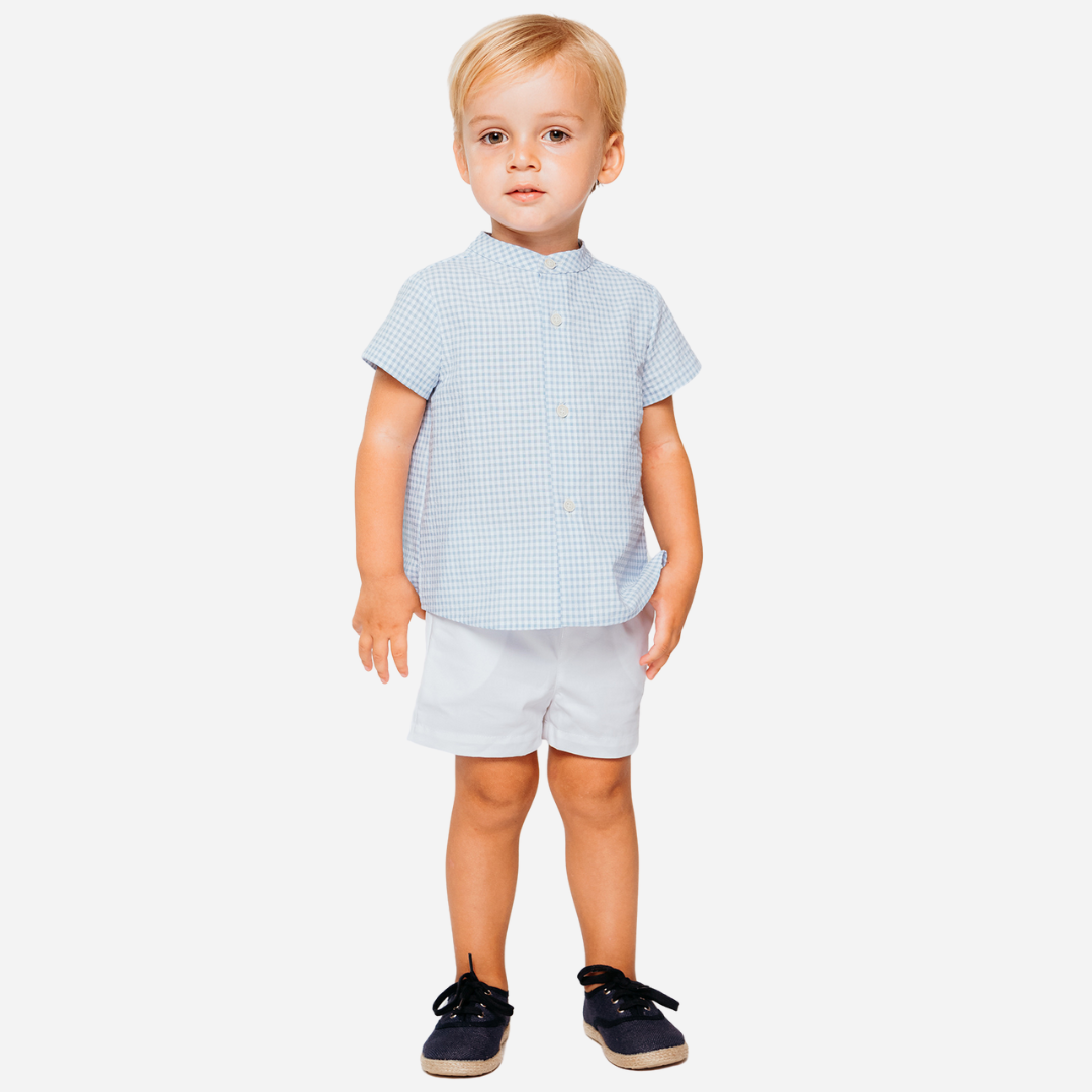 Sold at Bombon, designed by Fina Ejerique brand, a blue gingham shirt for babies and toddlers perfect for spring and summer. Model view