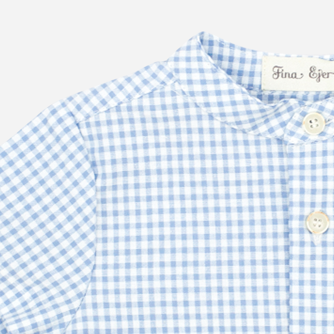 Sold at Bombon, designed by Fina Ejerique brand, a blue gingham shirt for babies and toddlers perfect for spring and summer. Zoom view