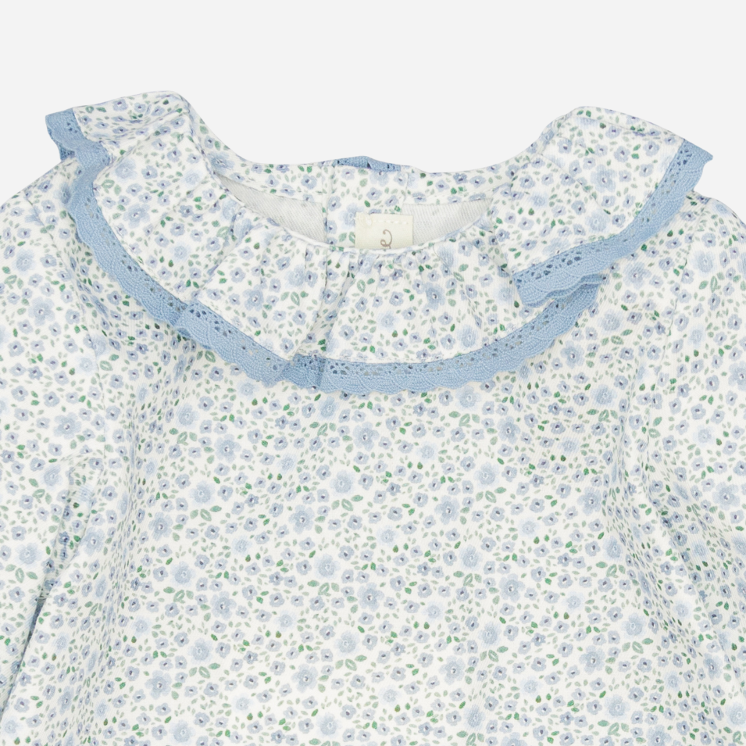 Sold at Bombon shop, designed by Fina Ejerique, a white floral viyella blouse with blue lace ruffle collar and long sleeves, styled to pair with matching blue corduroy bottoms. zoom