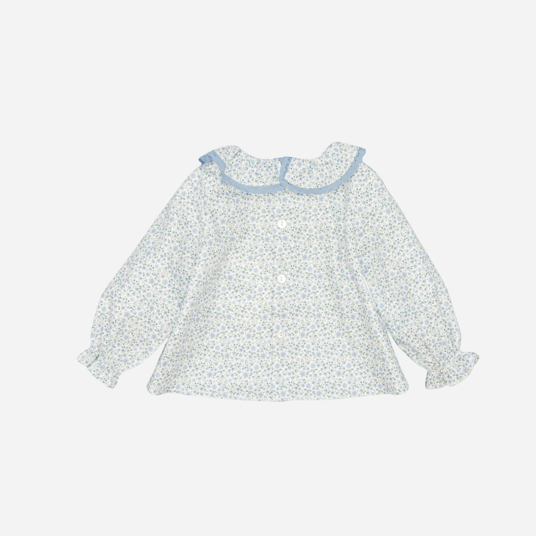 Sold at Bombon shop, designed by Fina Ejerique, a white floral viyella blouse with blue lace ruffle collar and long sleeves, styled to pair with matching blue corduroy bottoms. back