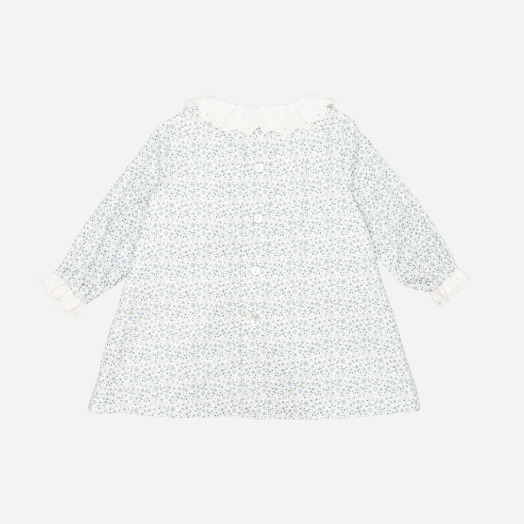 Sold at Bombon shop, designed by Fina Ejerique, a white floral viyella baby dress with smocked bodice, ruffle collar, and long sleeves. back