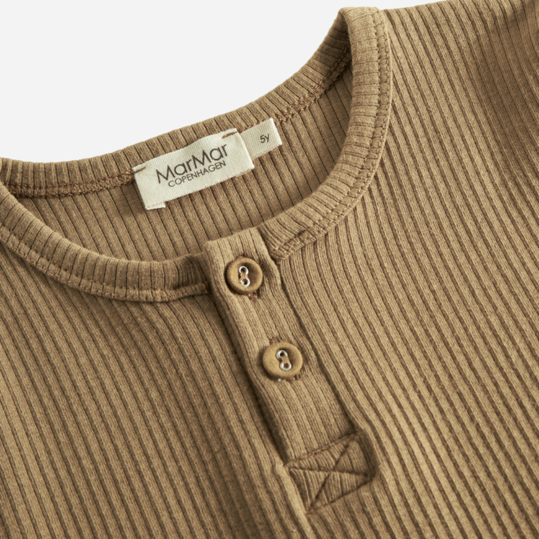 Sold at Bombon shop, designed by MarMar Copenhagen — caramel ribbed organic cotton long-sleeve baby top with buttoned neckline, part of a matching set.