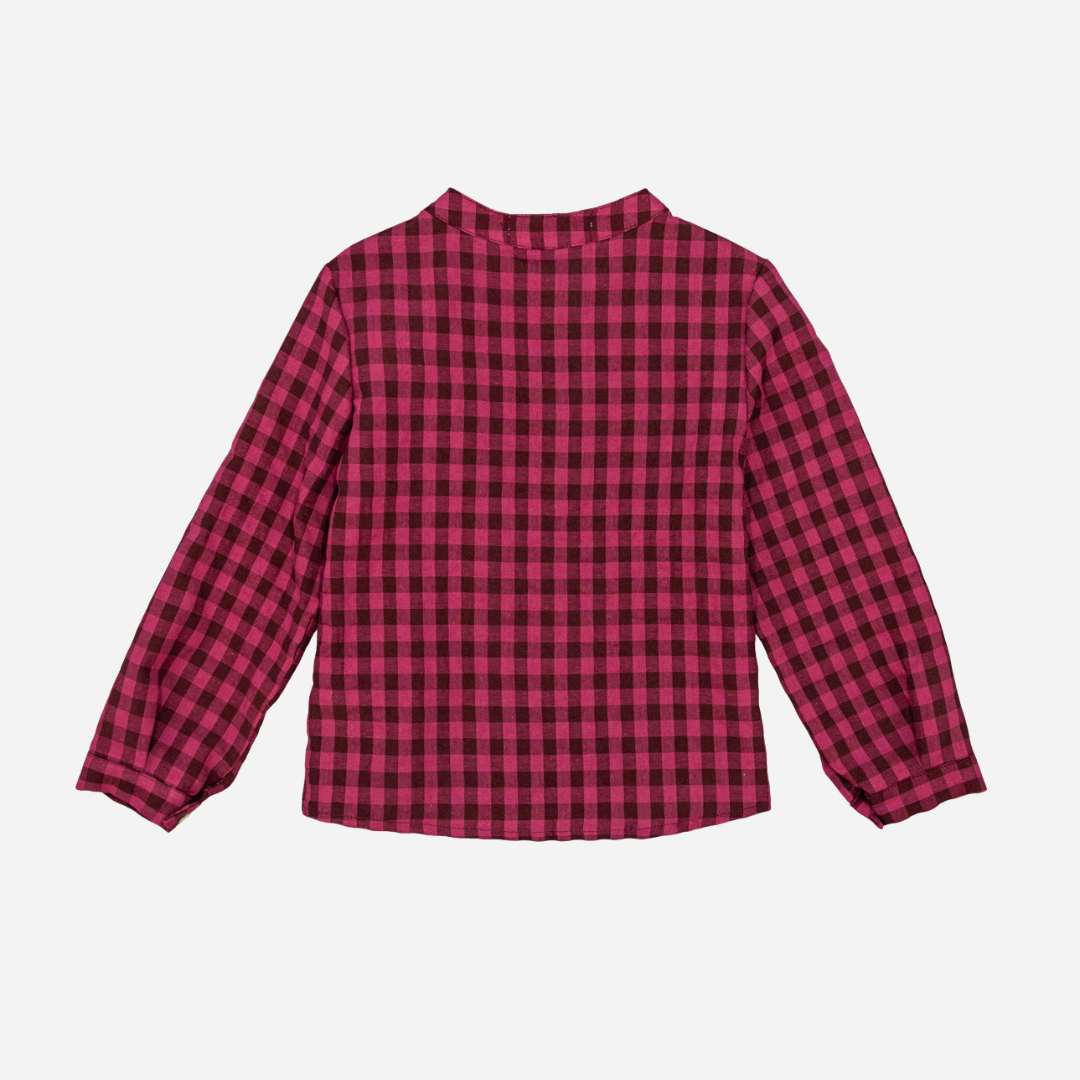 Sold at Bombon shop, designed by Fina Ejerique, a burgundy and black checkered cotton shirt with wooden buttons and long sleeves, styled to pair with the burgundy dog sweater.