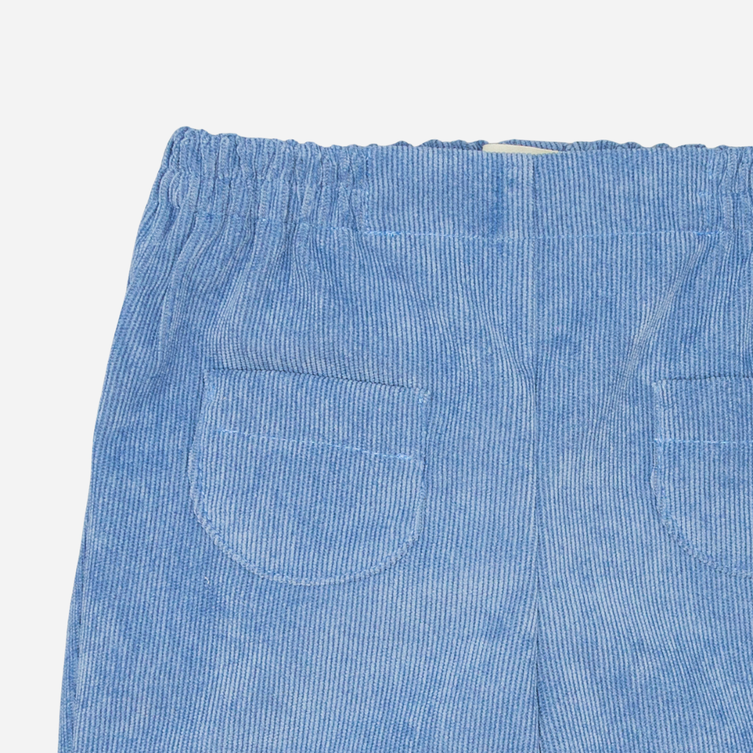 Sold at Bombon shop, designed by Fina Ejerique, blue corduroy baby trousers with elastic waistband and back pockets. zoom