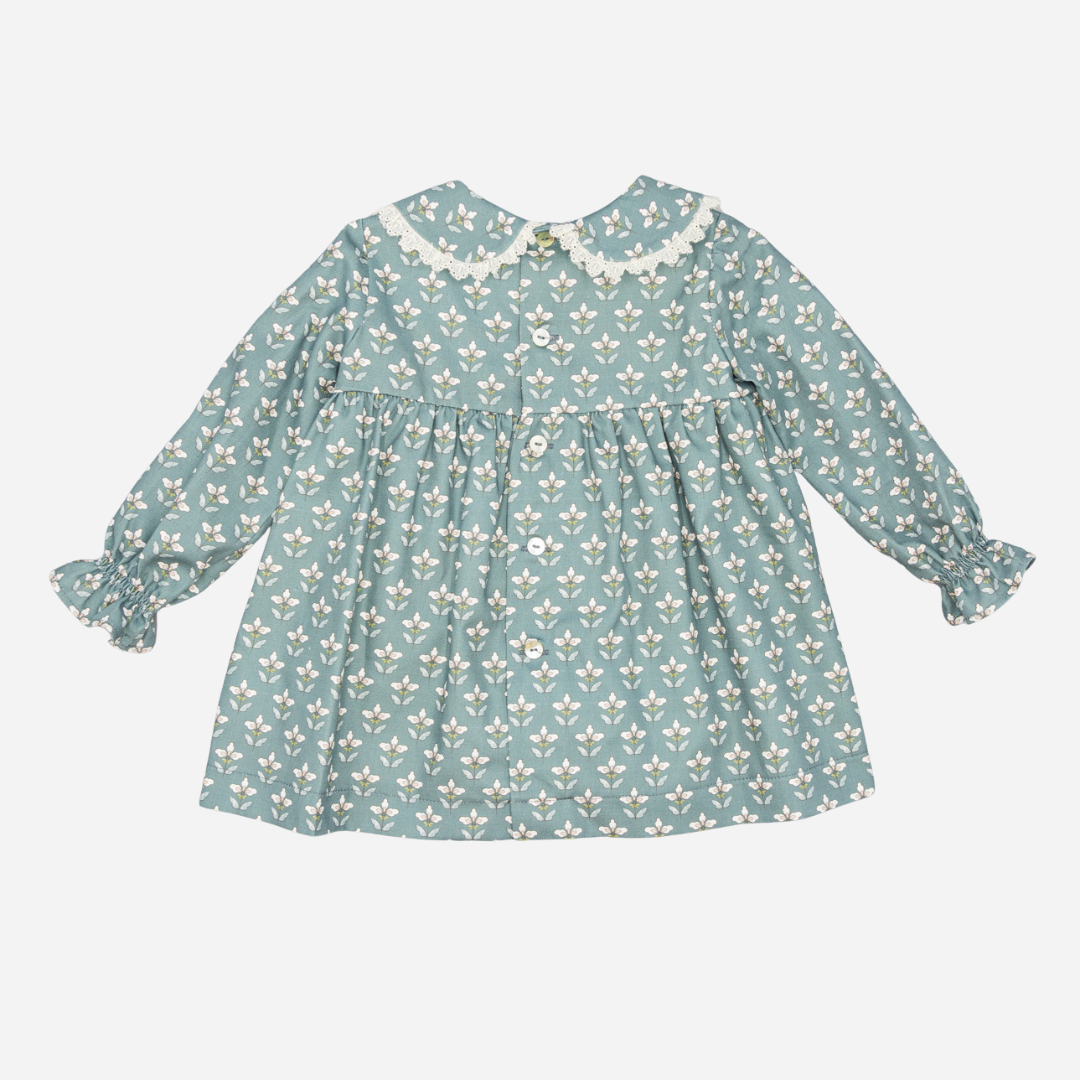 Sold at Bombon shop, designed by Fina Ejerique, a sage green floral baby dress with lace-trim collar and long sleeves. back