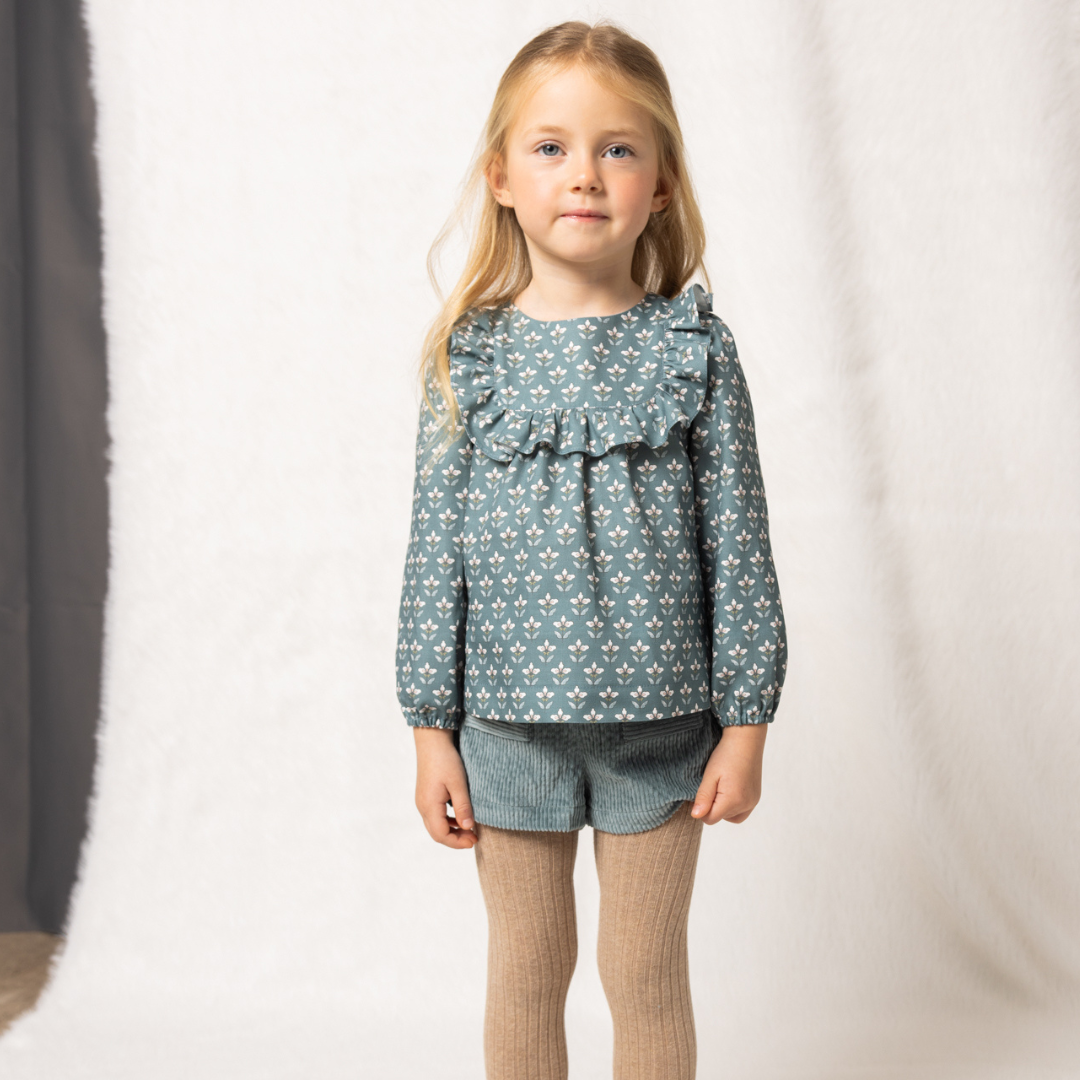 Sold at Bombon shop, designed by Fina Ejerique, green corduroy shorts with back pockets and bow detail, pairs perfectly with the green floral viyella blouse. model