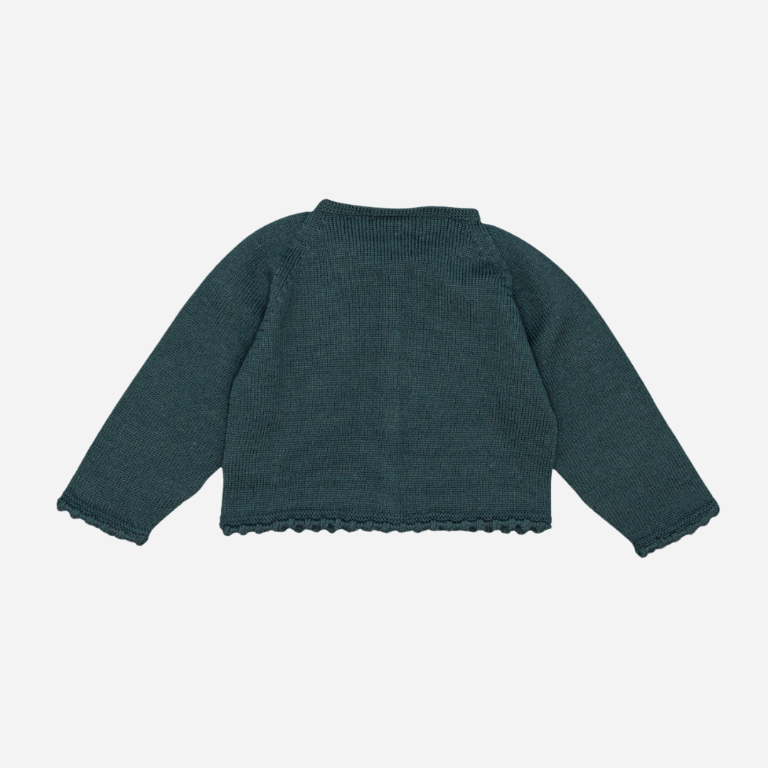 Sold at Bombon shop, designed by Fina Ejerique, a forest-green knit baby cardigan with scalloped trim and front buttons. back