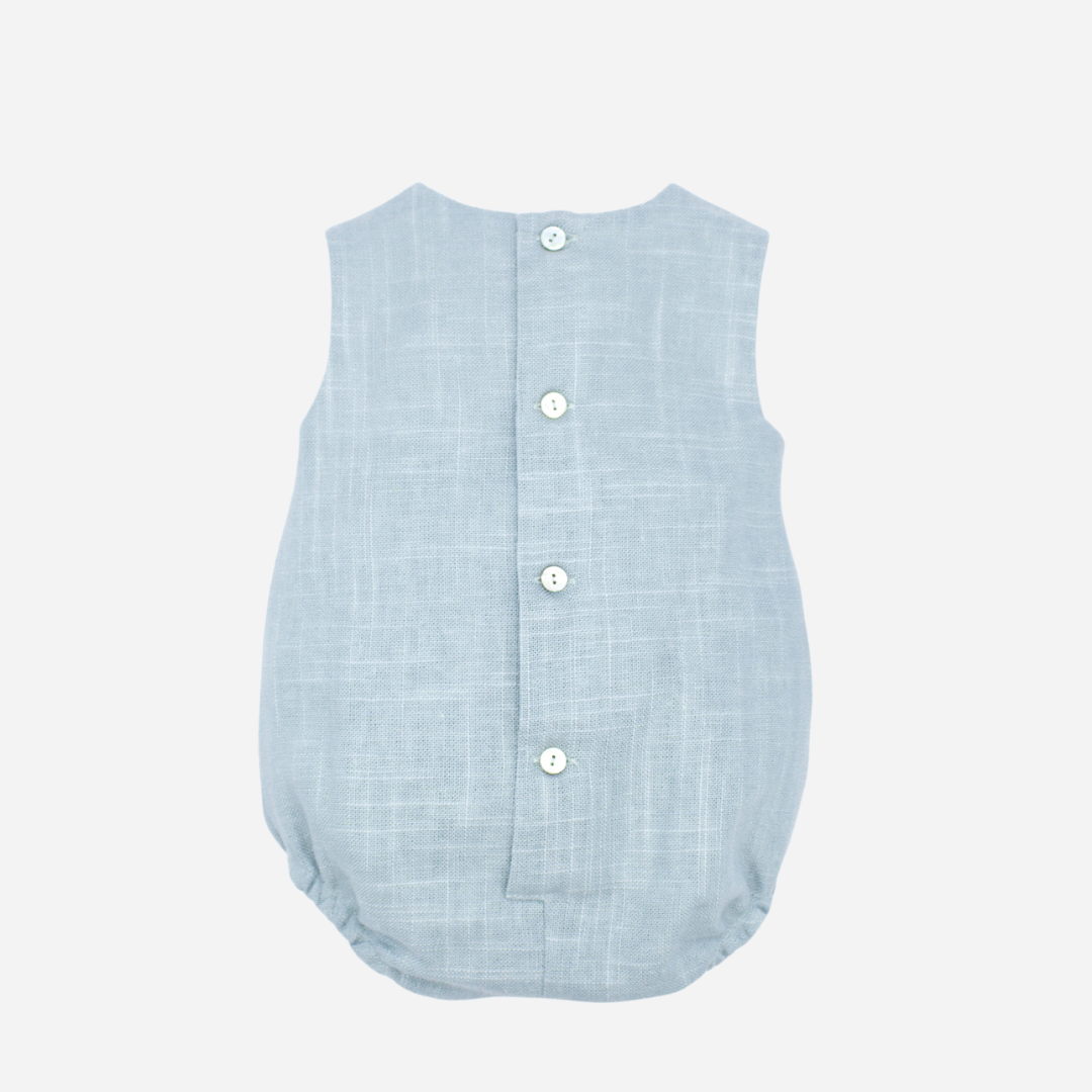 Sold at Bombon shop, designed by Fina Ejerique brand, green linen pleated baby romper perfect for spring and summer. Back view