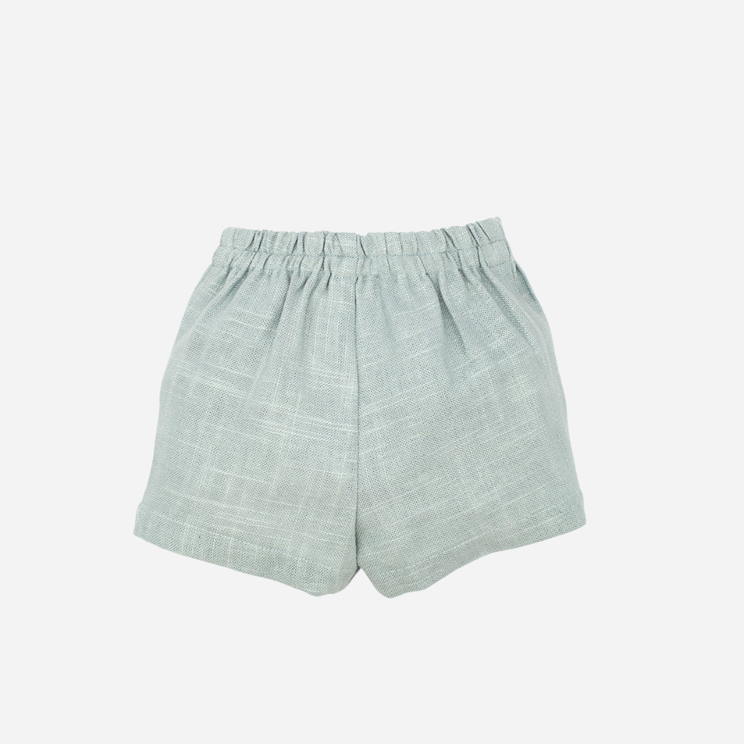 sold at Bombon shop, designed by fina ejerique brand, green linen shorts for babies and toddlers are perfect for spring and summer. back view