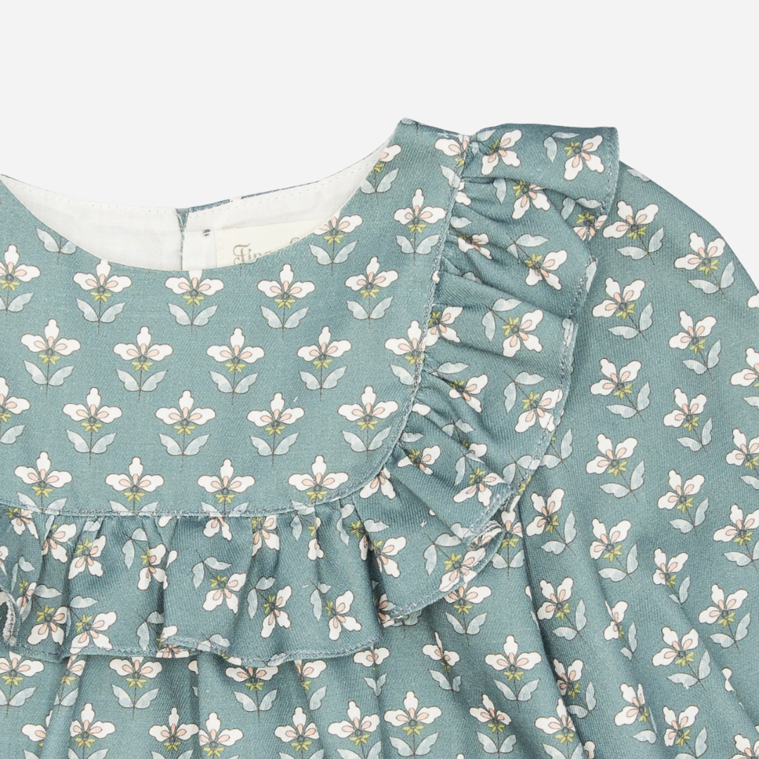 Sold at Bombon shop, designed by Fina Ejerique, a green floral viyella baby blouse with ruffled yoke and long sleeves, styled to pair with green corduroy shorts. zoom