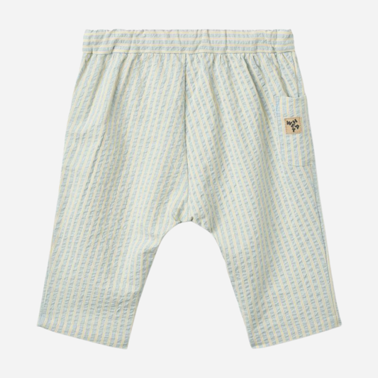 Sold at Bombon Shop, designed by Wheat, summer sky stripe organic cotton baby trousers with elastic waistband and soft blue vertical stripes.