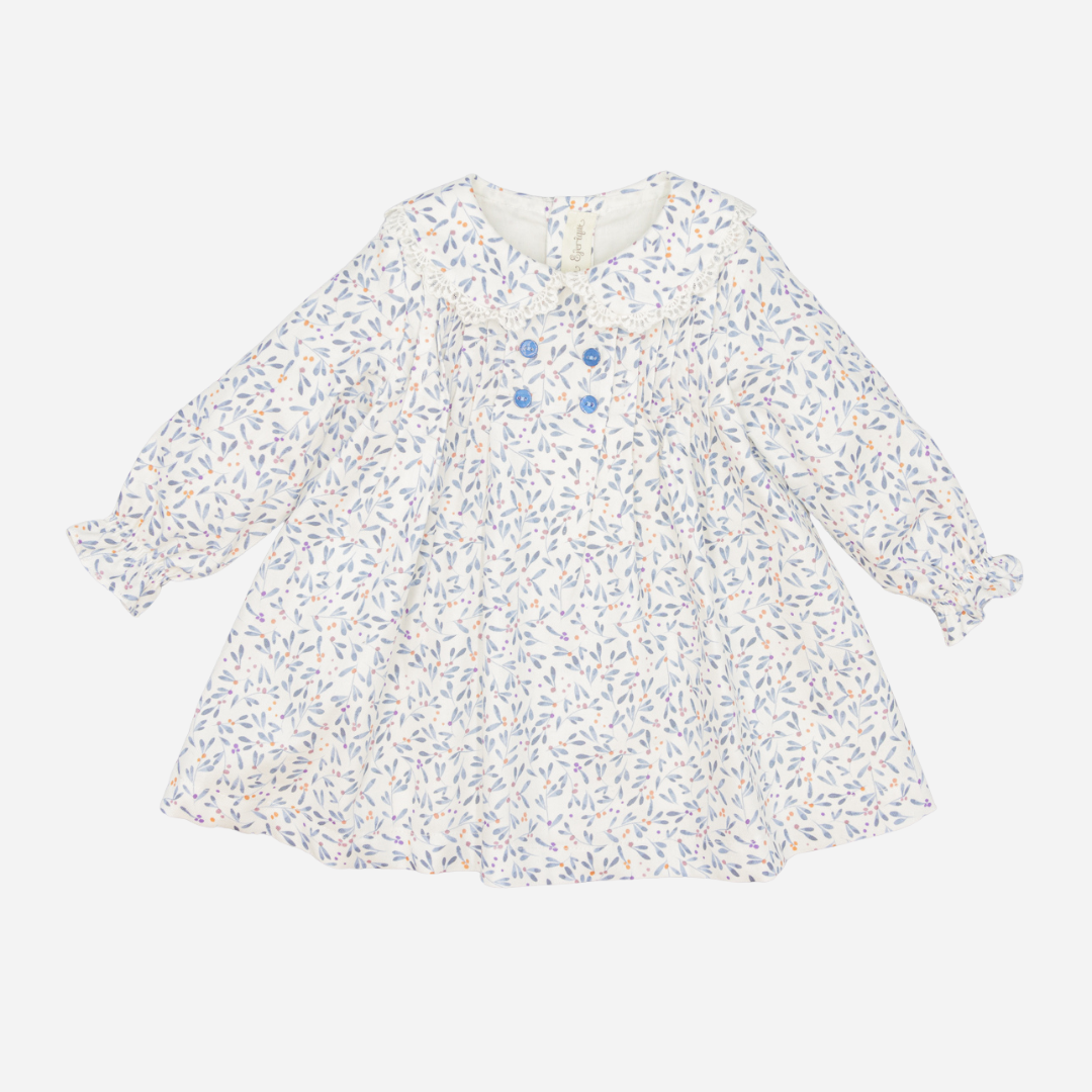 Sold at Bombon shop, designed by Fina Ejerique, a white baby dress with blue, lilac, and peach leaf print, lace-trim collar, blue buttons, and long sleeves. front