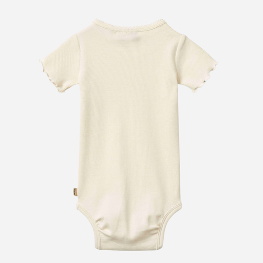 Sold at Bombon Shop, designed by Wheat, ivory organic cotton short sleeve baby bodysuit with a soft minimal silhouette.