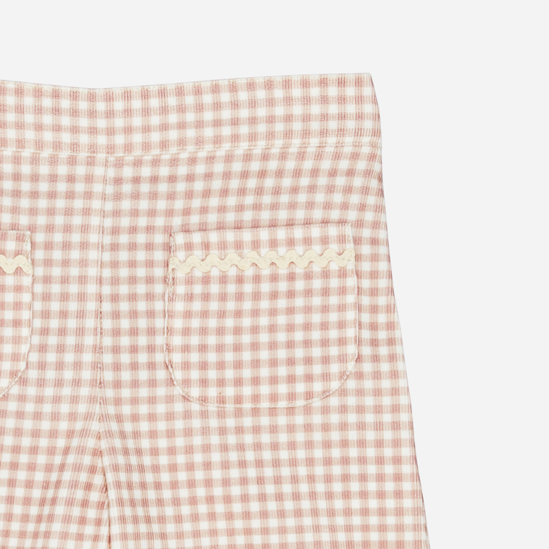 Sold at Bombon shop, designed by Fina Ejerique, pink gingham corduroy baby pants with ric-rac trim on the back pockets, styled to pair with the matching blouse. zoom