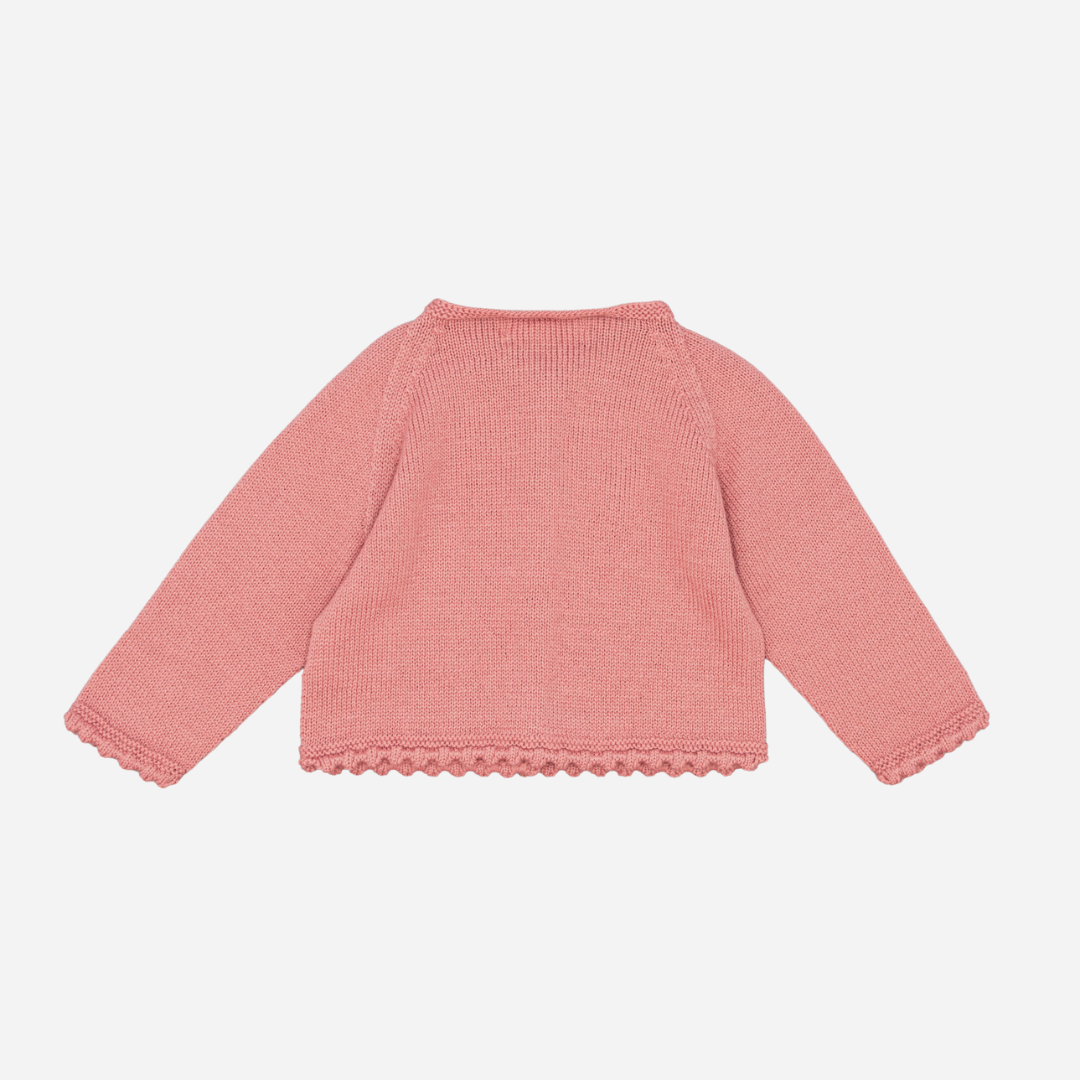 Sold at Bombon shop, designed by Fina Ejerique, a rose-pink knit baby cardigan with scalloped trim and front buttons. back