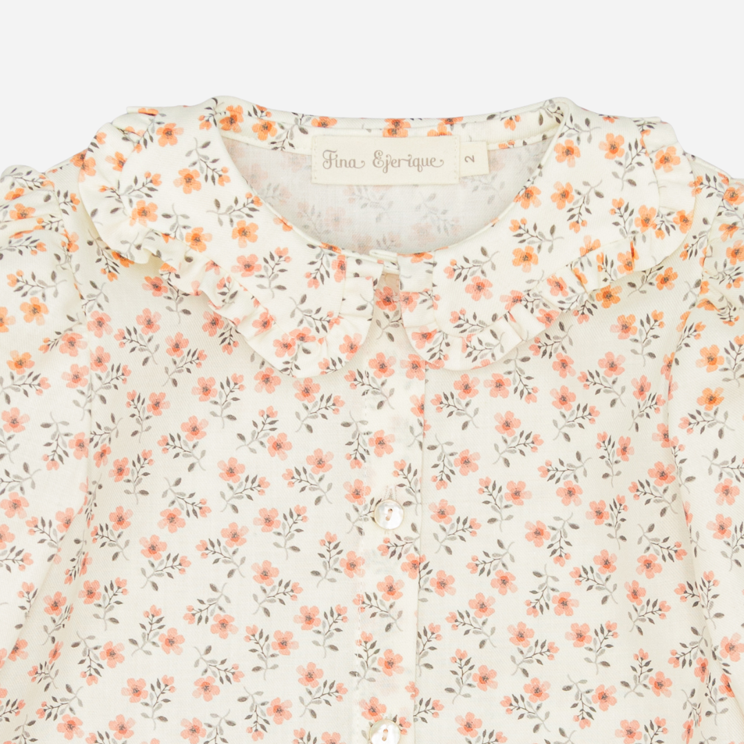 Sold at Bombon shop, designed by Fina Ejerique, floral viyella blouse with ruffled collar, pairs perfectly with the beige textured skirt and pink vest. zoom