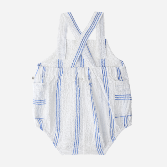 Sold at Bombon Shop, designed by 1+ in the family, ultramarine striped baby romper with adjustable straps and lightweight cotton fabric.