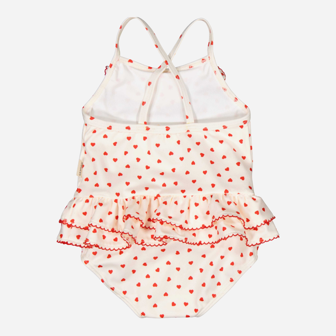 Sold at Bombon shop, designed by Mar Mar Copenhagen brand, this cute bathing suit in a small red heart print for baby girls and toddlers is perfect for spring and summer. back view