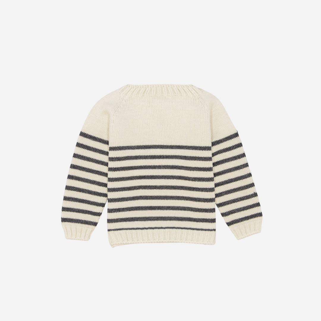 Sold at Bombon shop, designed by Fina Ejerique, a cream knit baby sweater with gray horizontal stripes, styled to pair with grey twill trousers. back