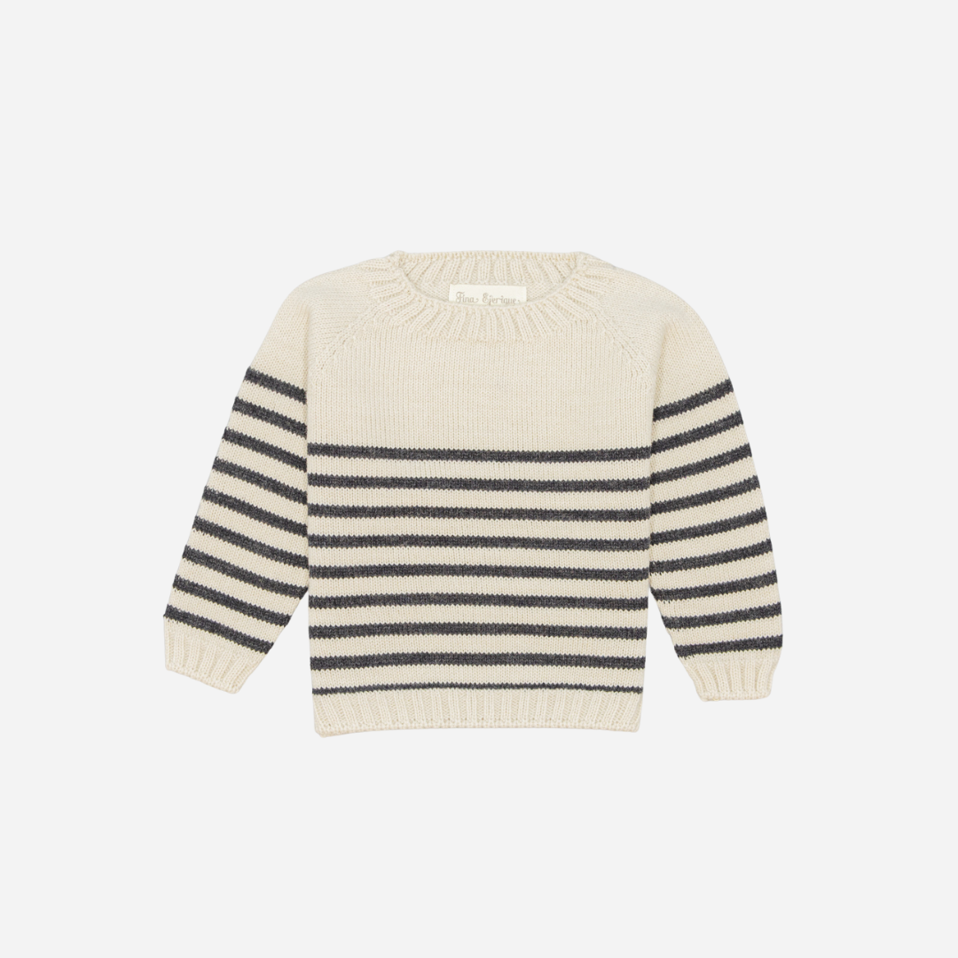 Sold at Bombon shop, designed by Fina Ejerique, a cream knit baby sweater with gray horizontal stripes, styled to pair with grey twill trousers. front