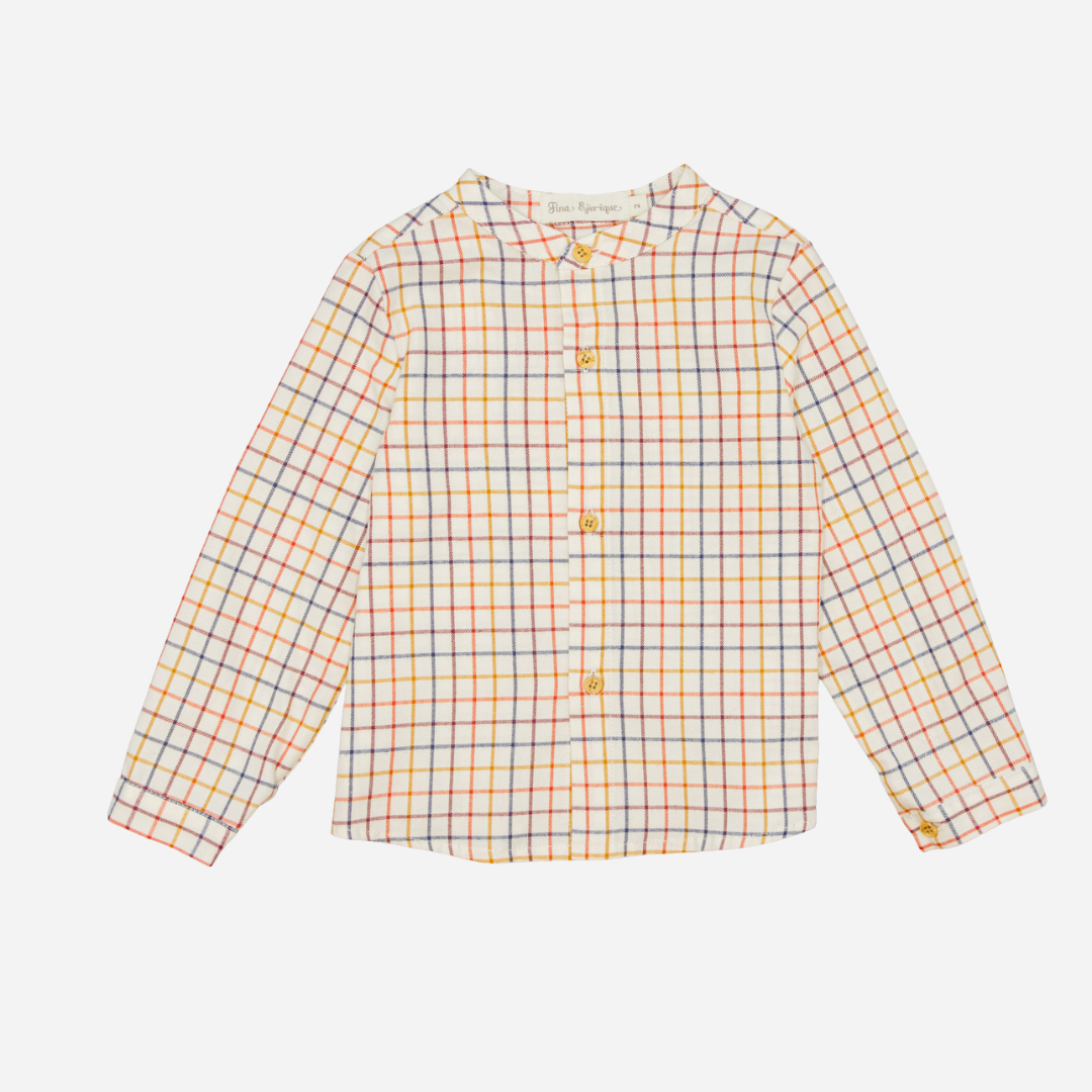 Sold at Bombon shop, designed by Fina Ejerique, a beige viyella baby shirt with red, mustard, and blue checkered pattern, wooden buttons, and long sleeves. front