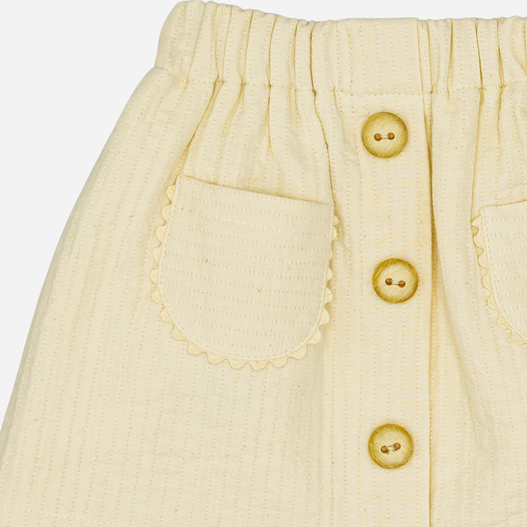 Sold at Bombon shop, designed by Fina Ejerique, beige textured skirt with button front and scalloped pockets, pairs perfectly with the floral blouse and pink vest. zoom