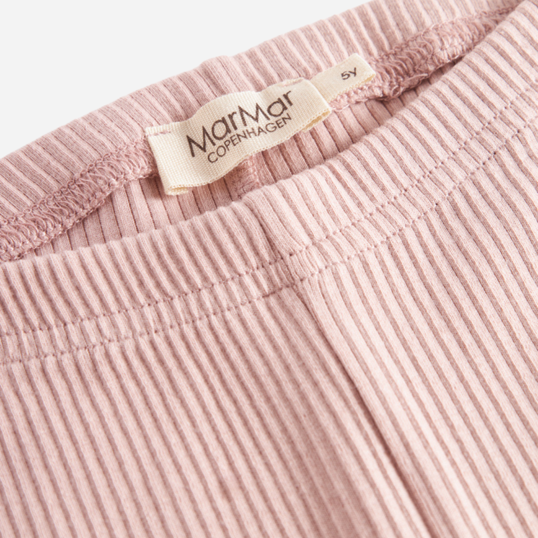 Sold at Bombon shop, designed by MarMar Copenhagen — blush pink ribbed organic cotton baby leggings, part of a matching set.