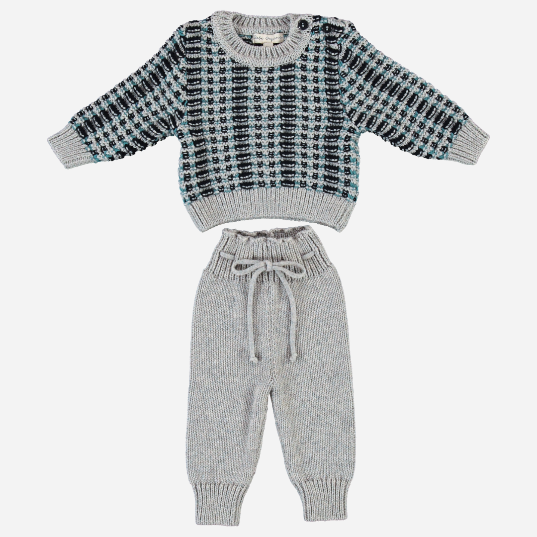 Sold at Bombon Shop, this cozy Bebe Organic knit set for baby and toddler boys includes a soft wool-blend sweater with a checkered jacquard pattern in grey, teal, and black, paired with matching drawstring knit pants — a warm and stylish outfit perfect for fall and winter days.