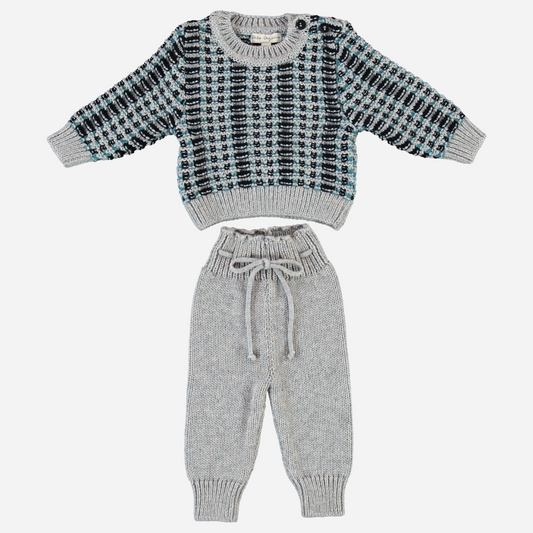 Sold at Bombon Shop, this cozy Bebe Organic knit set for baby and toddler boys includes a soft wool-blend sweater with a checkered jacquard pattern in grey, teal, and black, paired with matching drawstring knit pants — a warm and stylish outfit perfect for fall and winter days.