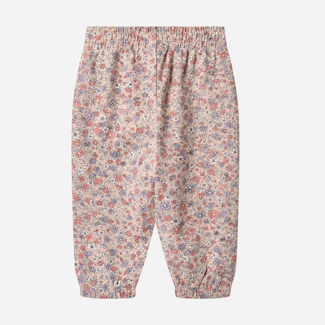 Sold at Bombon shop, designed by Wheat, these floral print pants feature an elastic waist and cuffs in soft rose and lavender tones. back