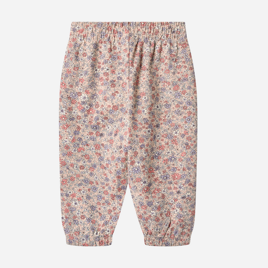 Sold at Bombon shop, designed by Wheat, these floral print pants feature an elastic waist and cuffs in soft rose and lavender tones. back