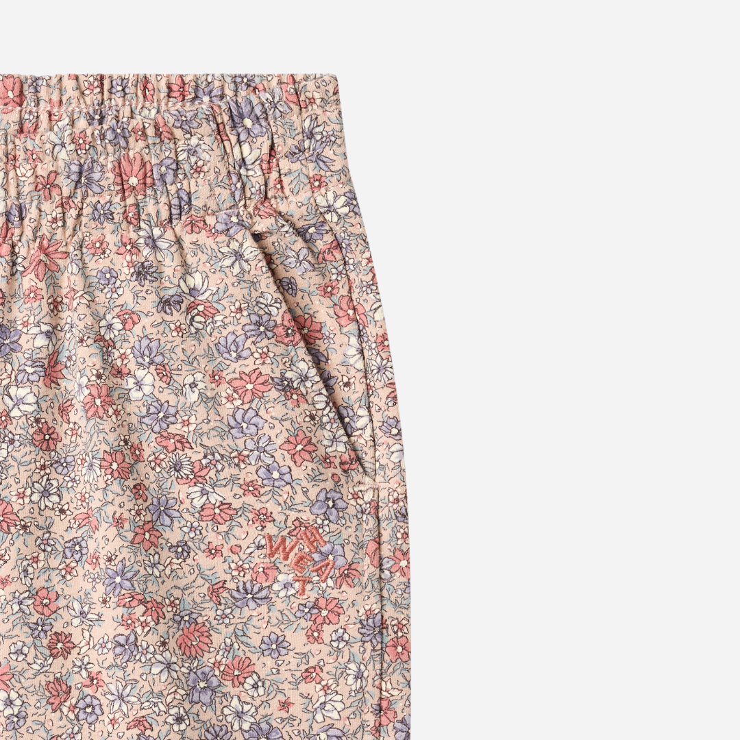 Sold at Bombon shop, designed by Wheat, these floral print pants feature an elastic waist and cuffs in soft rose and lavender tones. top
