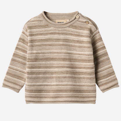 Sold at Bombon shop, designed by Wheat — knit baby sweater in warm sand stripe with shoulder buttons and soft texture. front