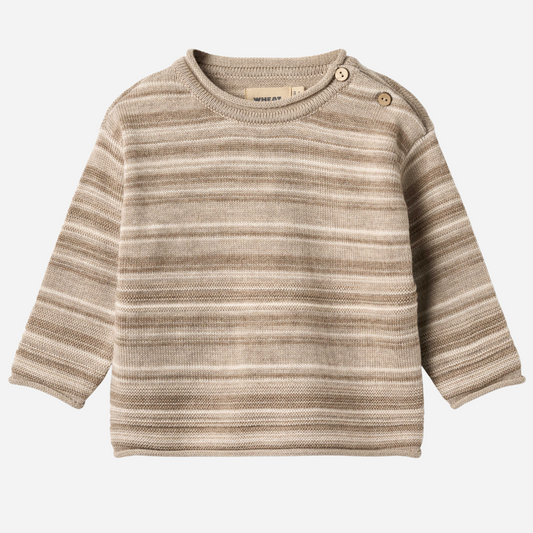 Sold at Bombon shop, designed by Wheat — knit baby sweater in warm sand stripe with shoulder buttons and soft texture. front