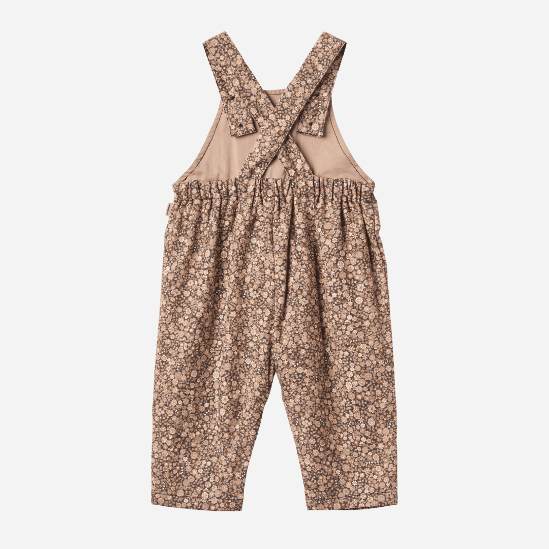 Sold at Bombon shop, designed by Wheat, this baby overall features an allover black sea garden floral print with adjustable button straps and snap closures along the inseam. back
