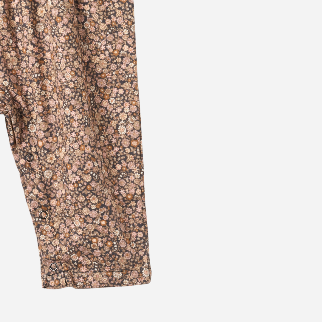 Sold at Bombon shop, designed by Wheat, this baby overall features an allover black sea garden floral print with adjustable button straps and snap closures along the inseam. bottom