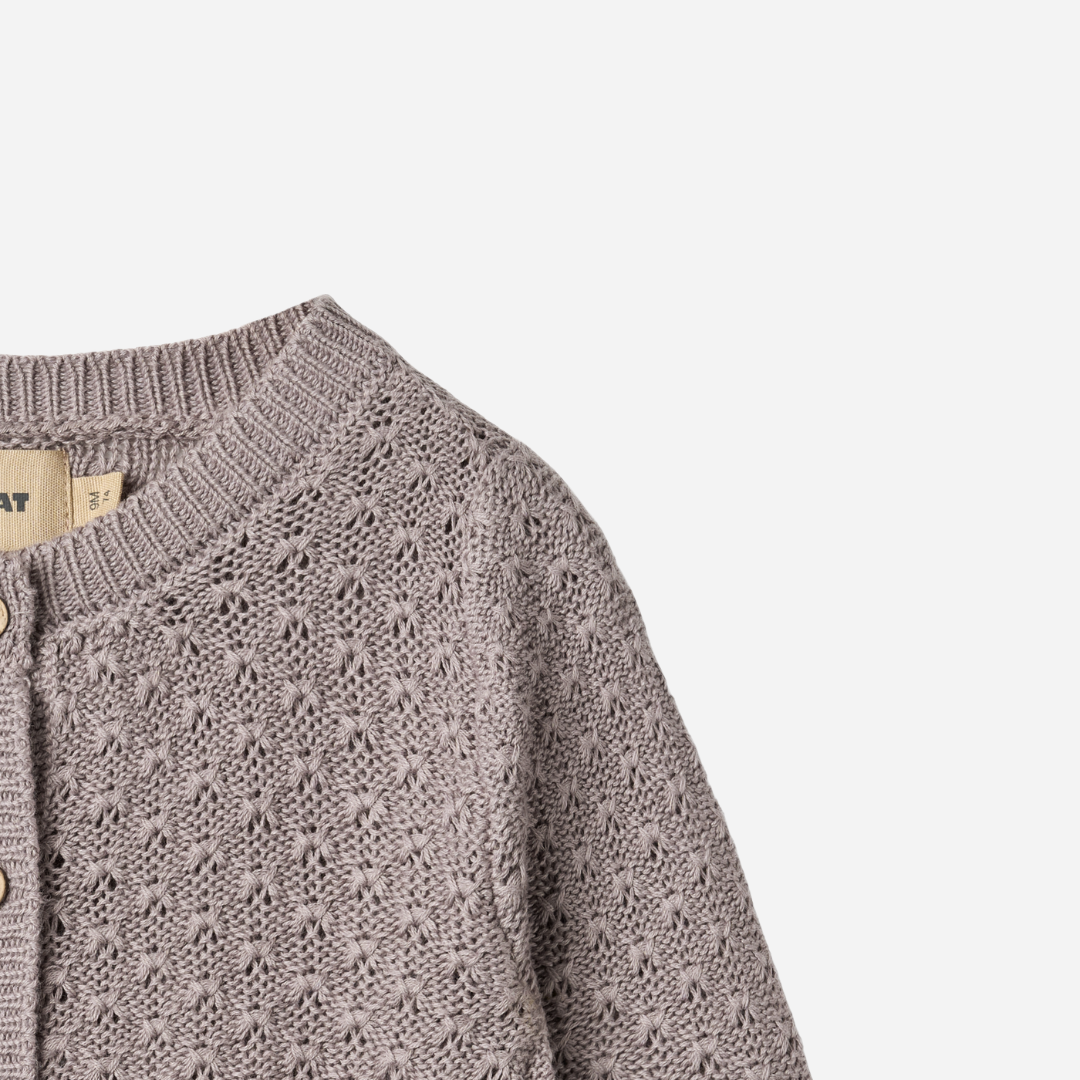 Sold at Bombon shop, designed by Wheat, this dusty purple pointelle cardigan features wooden buttons and a cozy knit texture. top