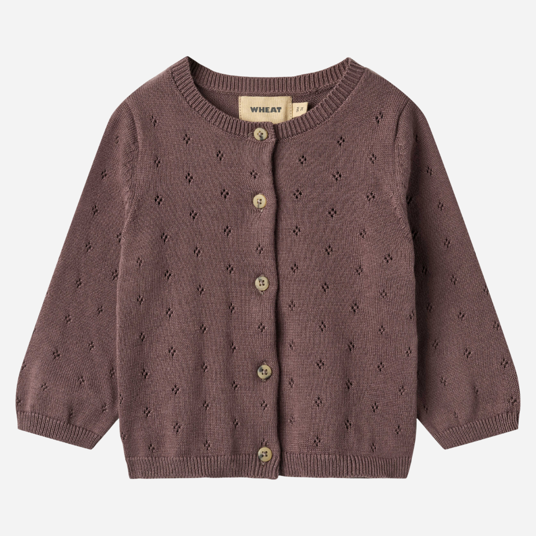 Sold at Bombon shop, designed by Wheat — plum-colored baby cardigan with delicate pointelle knit pattern, front button closure, and ribbed edges. front