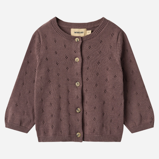 Sold at Bombon shop, designed by Wheat — plum-colored baby cardigan with delicate pointelle knit pattern, front button closure, and ribbed edges. front