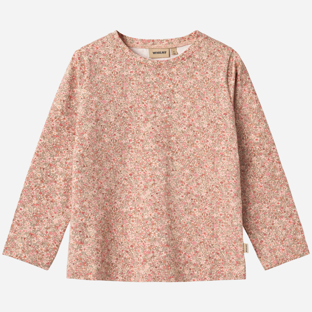 Sold at Bombon shop, designed by Wheat, this long-sleeve top features a delicate dusty pink floral print on a soft cotton blend. front