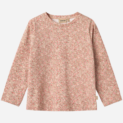 Sold at Bombon shop, designed by Wheat, this long-sleeve top features a delicate dusty pink floral print on a soft cotton blend. front