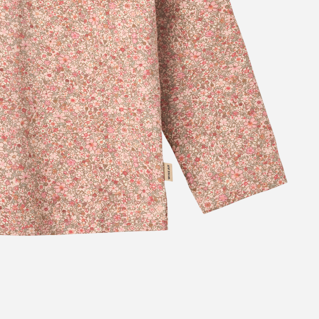 Sold at Bombon shop, designed by Wheat, this long-sleeve top features a delicate dusty pink floral print on a soft cotton blend. zoom bottom