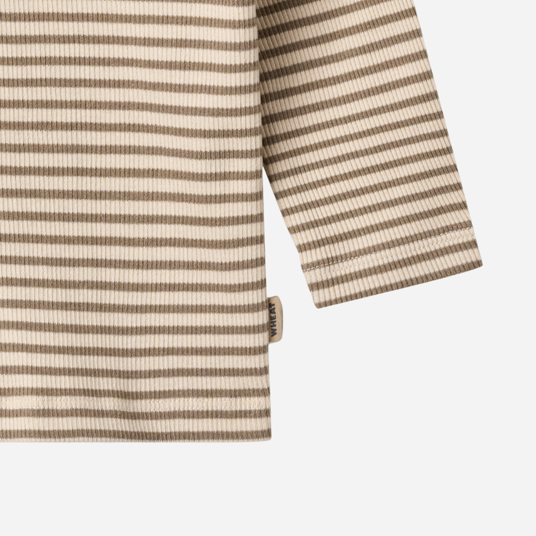 Sold at Bombon shop, designed by Wheat — ribbed long-sleeve top with stone and cream stripes and shoulder snap detail. bottom